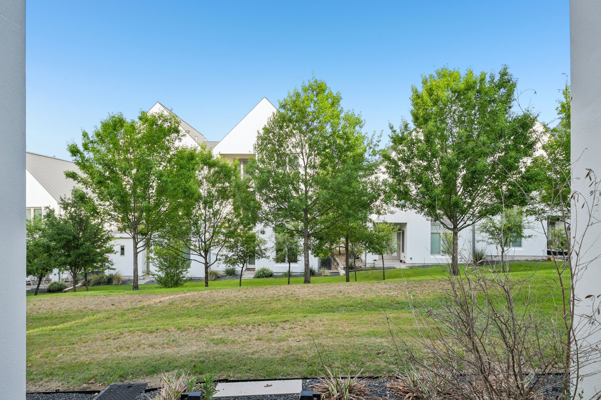2518 Watkins Way Austin, TX 78746 - Photo 25 of 28 a view of white house with a yard