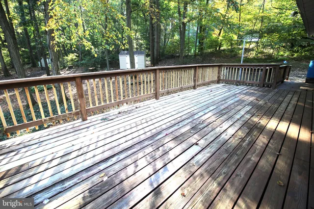 a balcony with wooden floor and trees