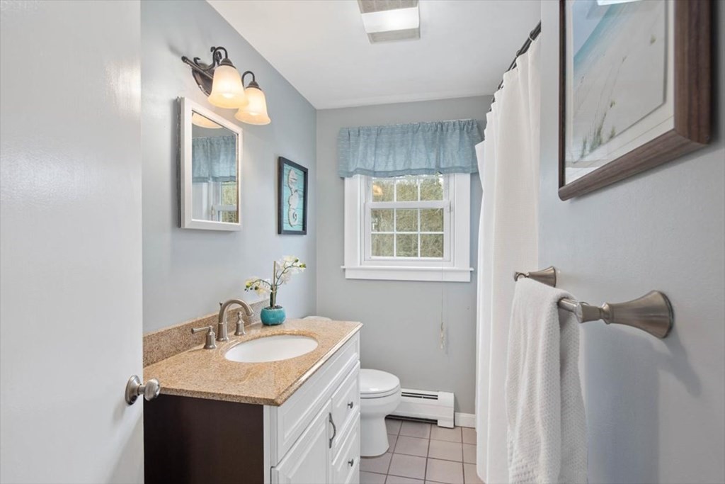 53 Winter Street Kingston, MA 02364 - Photo 16 of 28 a bathroom with a sink vanity and a toilet
