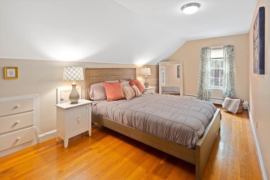 53 Winter Street Kingston, MA 02364 - Photo 19 of 28 a bedroom with a bed and wooden floor
