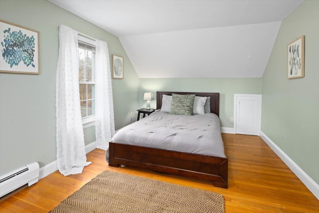 53 Winter Street Kingston, MA 02364 - Photo 20 of 28 a bedroom with a bed and wooden floor