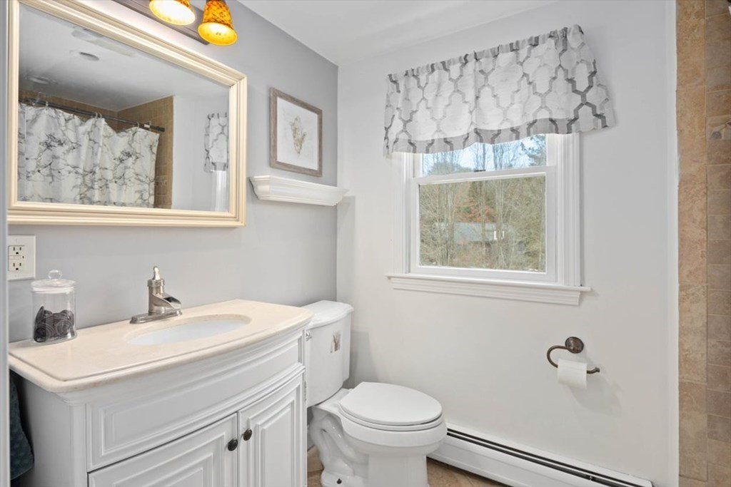 53 Winter Street Kingston, MA 02364 - Photo 22 of 28 a bathroom with a sink mirror vanity and toilet