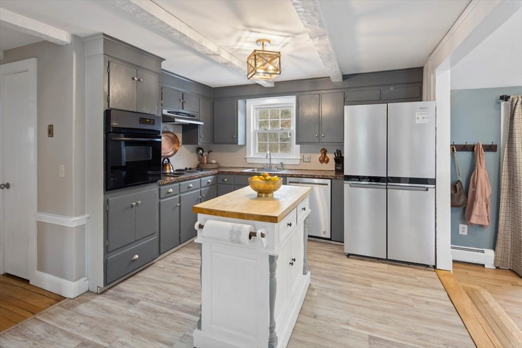 53 Winter Street Kingston, MA 02364 - Photo 9 of 28 a kitchen with wooden cabinets and stainless steel appliances