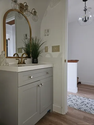 a bathroom with a sink a mirror and vanity