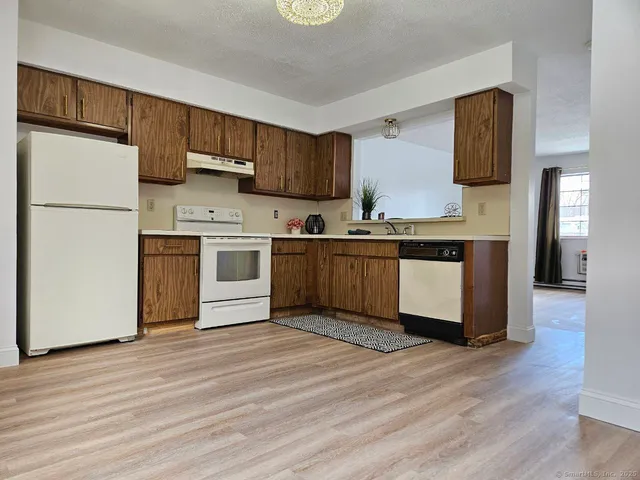 a kitchen with stainless steel appliances granite countertop a refrigerator a stove a sink and a microwave