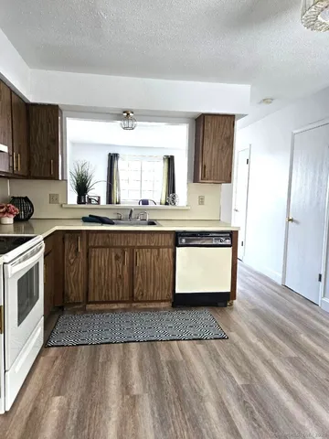 a kitchen with granite countertop a sink and cabinets