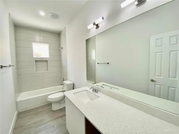 an empty room with ceiling fan and window