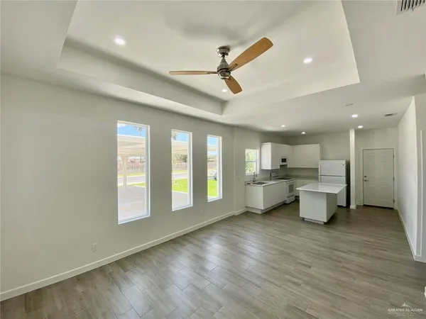 a kitchen with white cabinets and white appliances