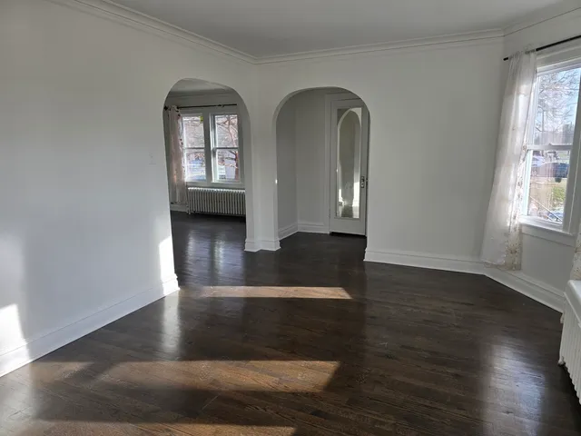 wooden floor in a hall with a window