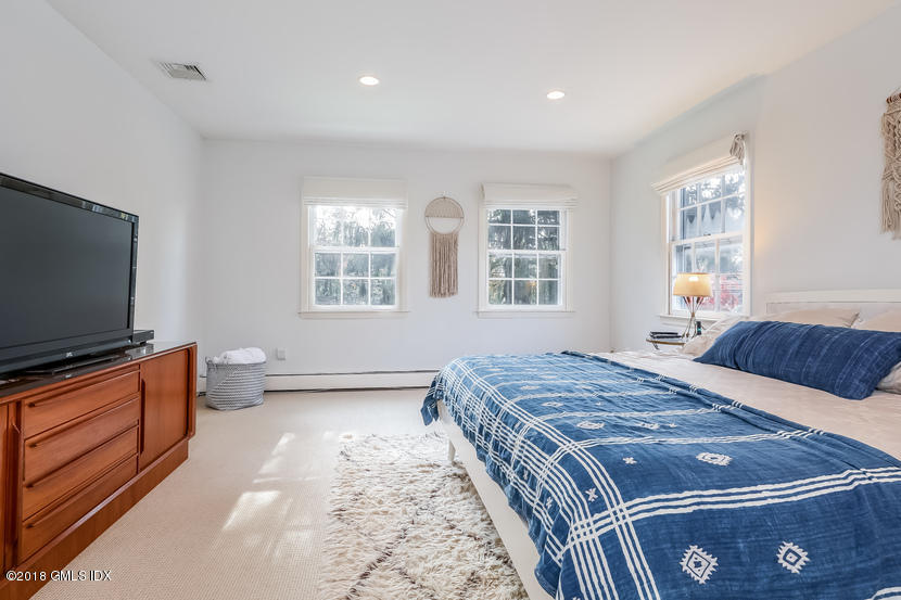 105 Lockwood Road Riverside, CT 06878 - Photo 11 of 22 a bedroom with a bed and flat screen tv