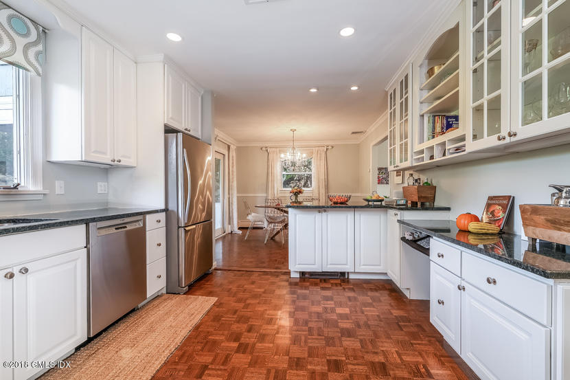 105 Lockwood Road Riverside, CT 06878 - Photo 8 of 22 a kitchen with stainless steel appliances granite countertop a refrigerator and a stove top oven