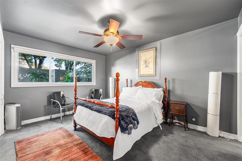 10406 Crestover Drive Dallas, TX 75229 - Photo 12 of 30 a bedroom with a bed and a chandelier