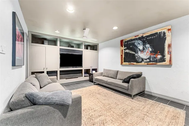 a bathroom with a granite countertop sink toilet a mirror and shower