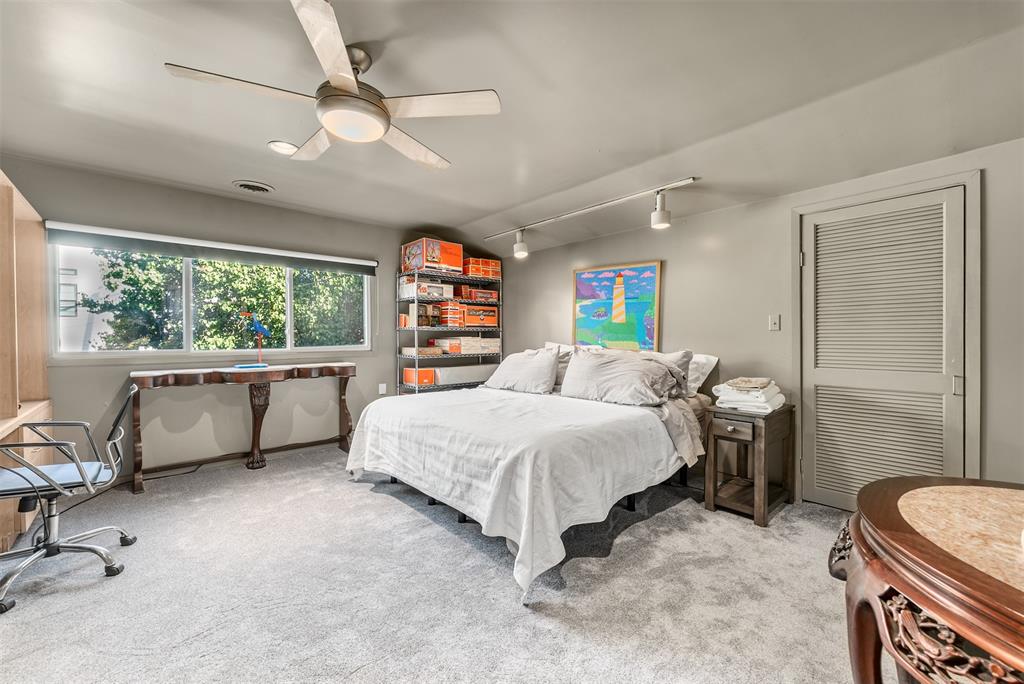 10406 Crestover Drive Dallas, TX 75229 - Photo 17 of 30 a bedroom with a bed dresser and a window