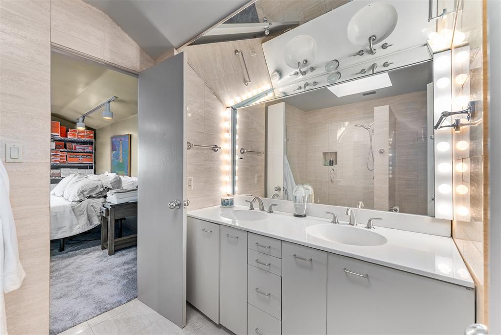 10406 Crestover Drive Dallas, TX 75229 - Photo 18 of 30 a spacious bathroom with a double vanity sink and a mirror