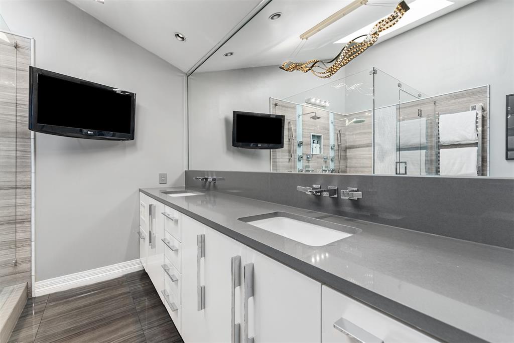 10406 Crestover Drive Dallas, TX 75229 - Photo 21 of 30 a spacious bathroom with a granite countertop double vanity and a mirror