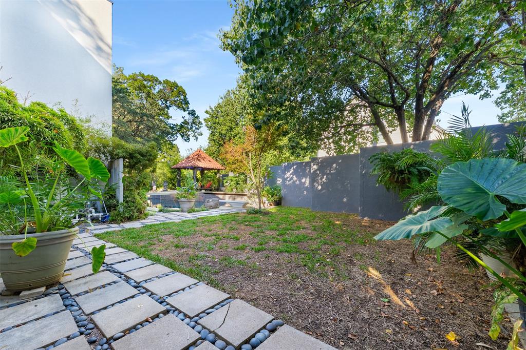 10406 Crestover Drive Dallas, TX 75229 - Photo 25 of 30 a view of a yard with plants and a fountain