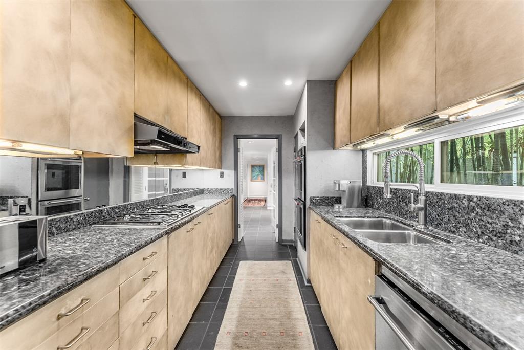 10406 Crestover Drive Dallas, TX 75229 - Photo 8 of 30 a large kitchen with stainless steel appliances granite countertop a sink and stove