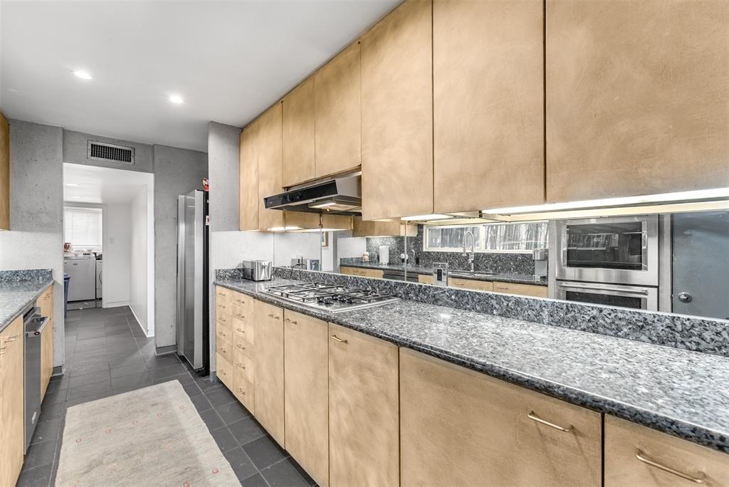 10406 Crestover Drive Dallas, TX 75229 - Photo 10 of 30 a kitchen with stainless steel appliances granite countertop a sink a stove and a refrigerator