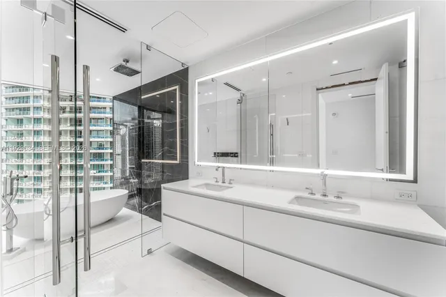 a spacious bathroom with a double vanity sink and mirror