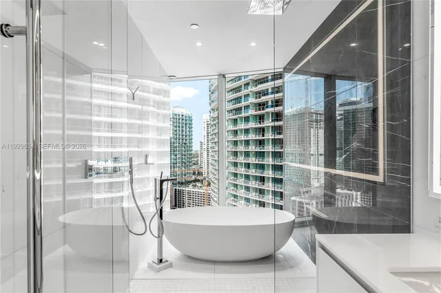 a bathroom with a bathtub and a shower