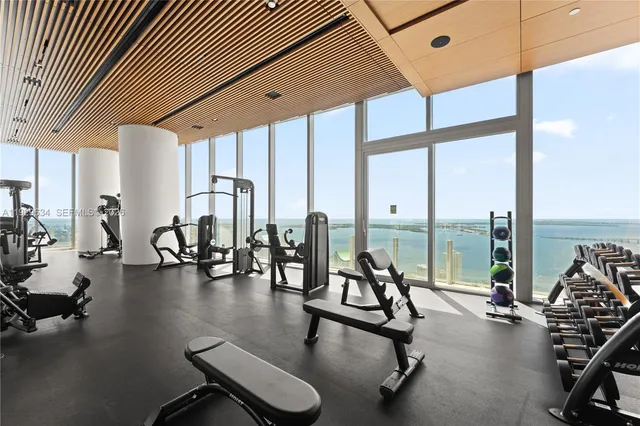 a view of a room with gym equipment and floor to ceiling window