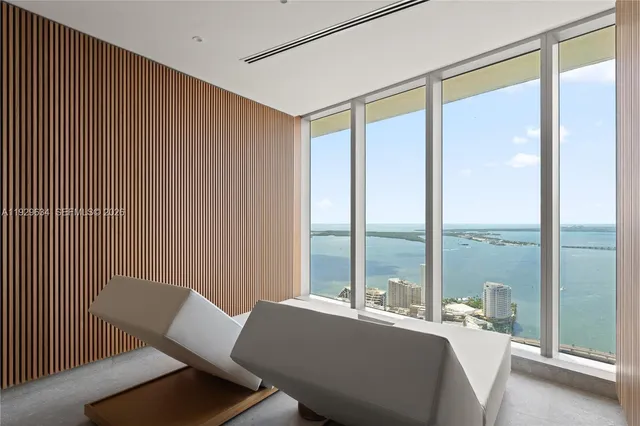 a room with a bed and a large window