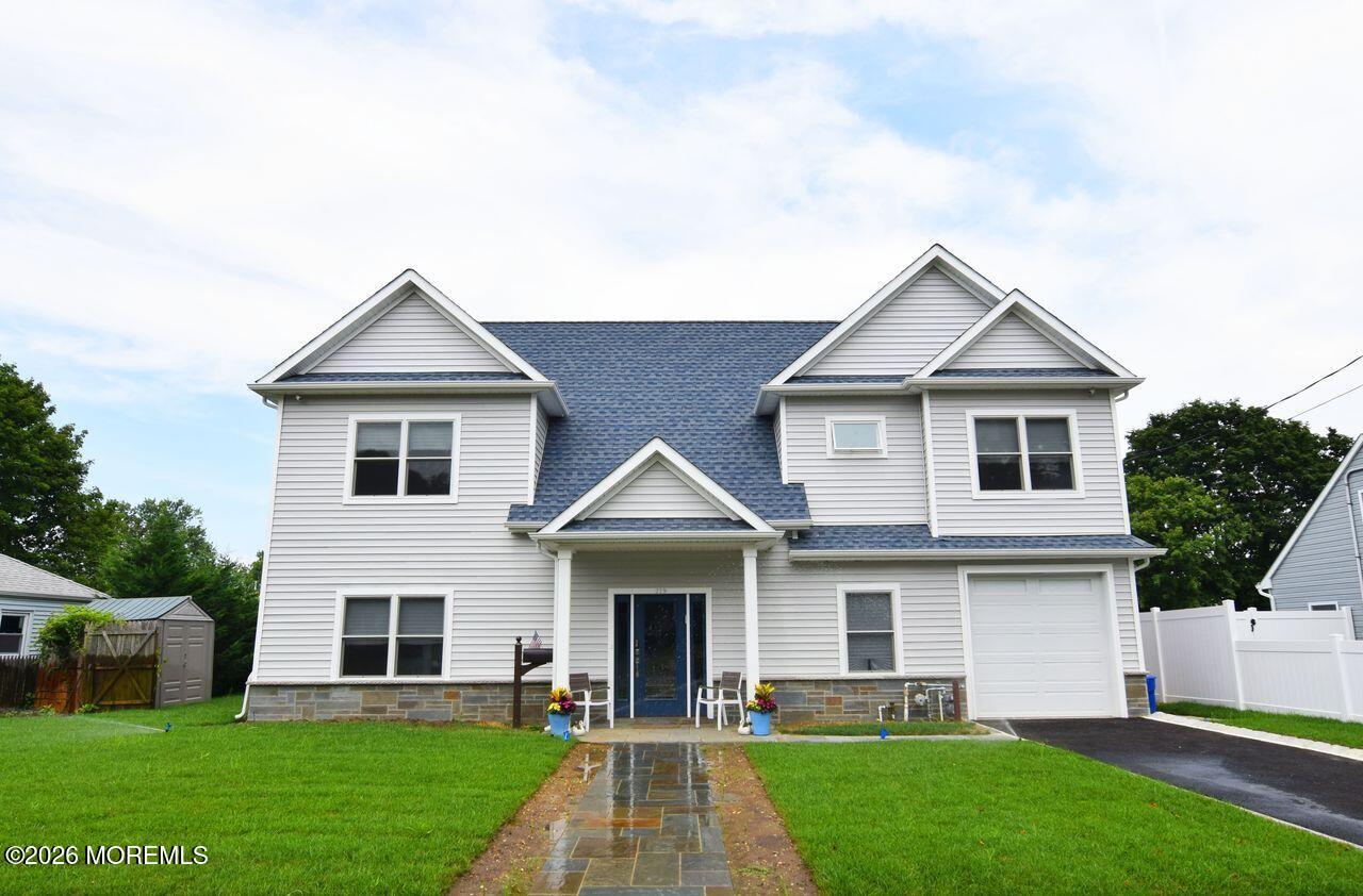 229 Lockwood Avenue, Unit WINTER Long Branch, NJ 07740 - Photo 1 of 19 a front view of a house with a yard and trees