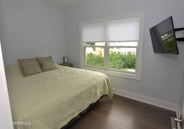 a bed sitting in a bedroom next to a window