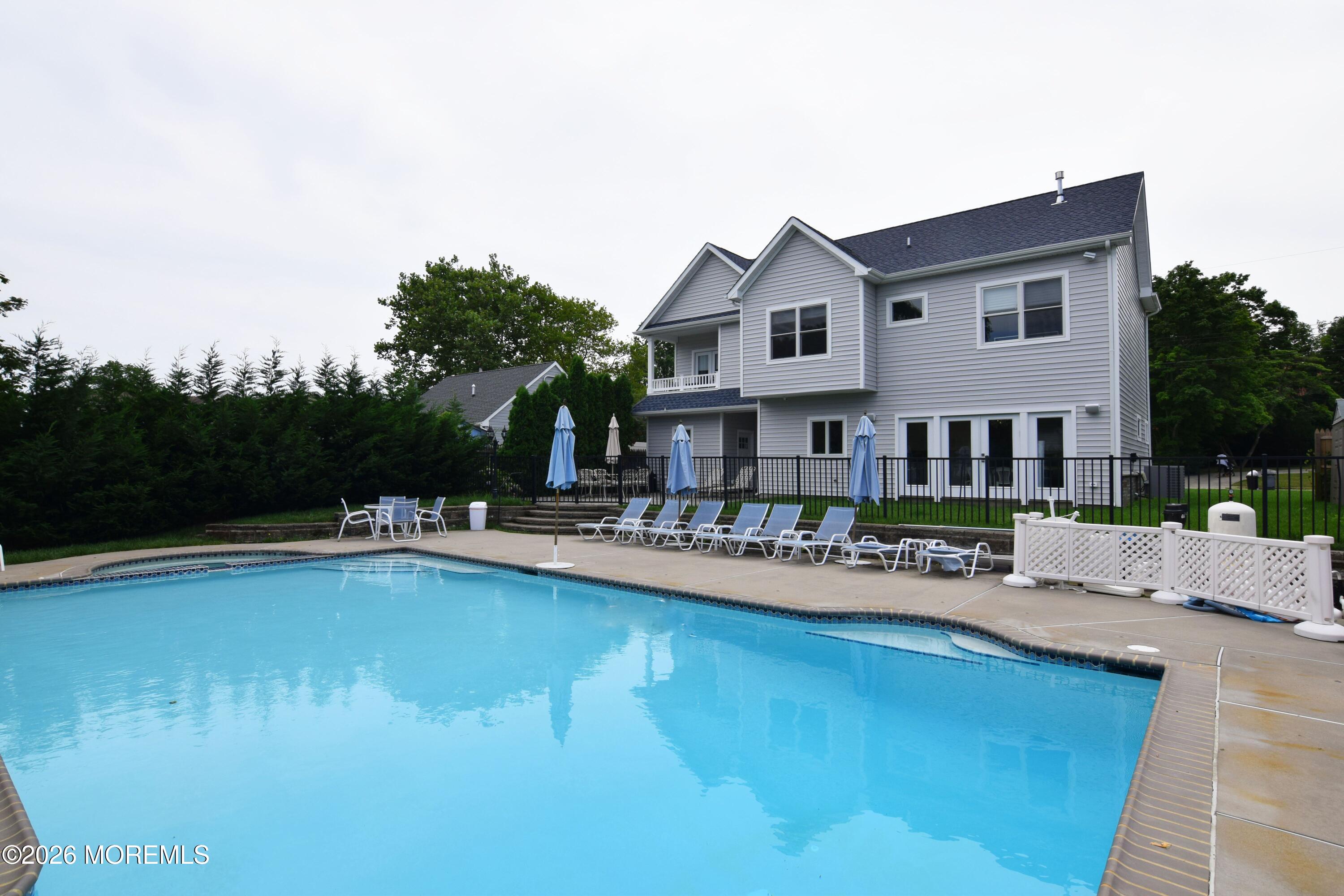229 Lockwood Avenue, Unit WINTER Long Branch, NJ 07740 - Photo 17 of 19 a front view of a house with swimming pool having outdoor seating