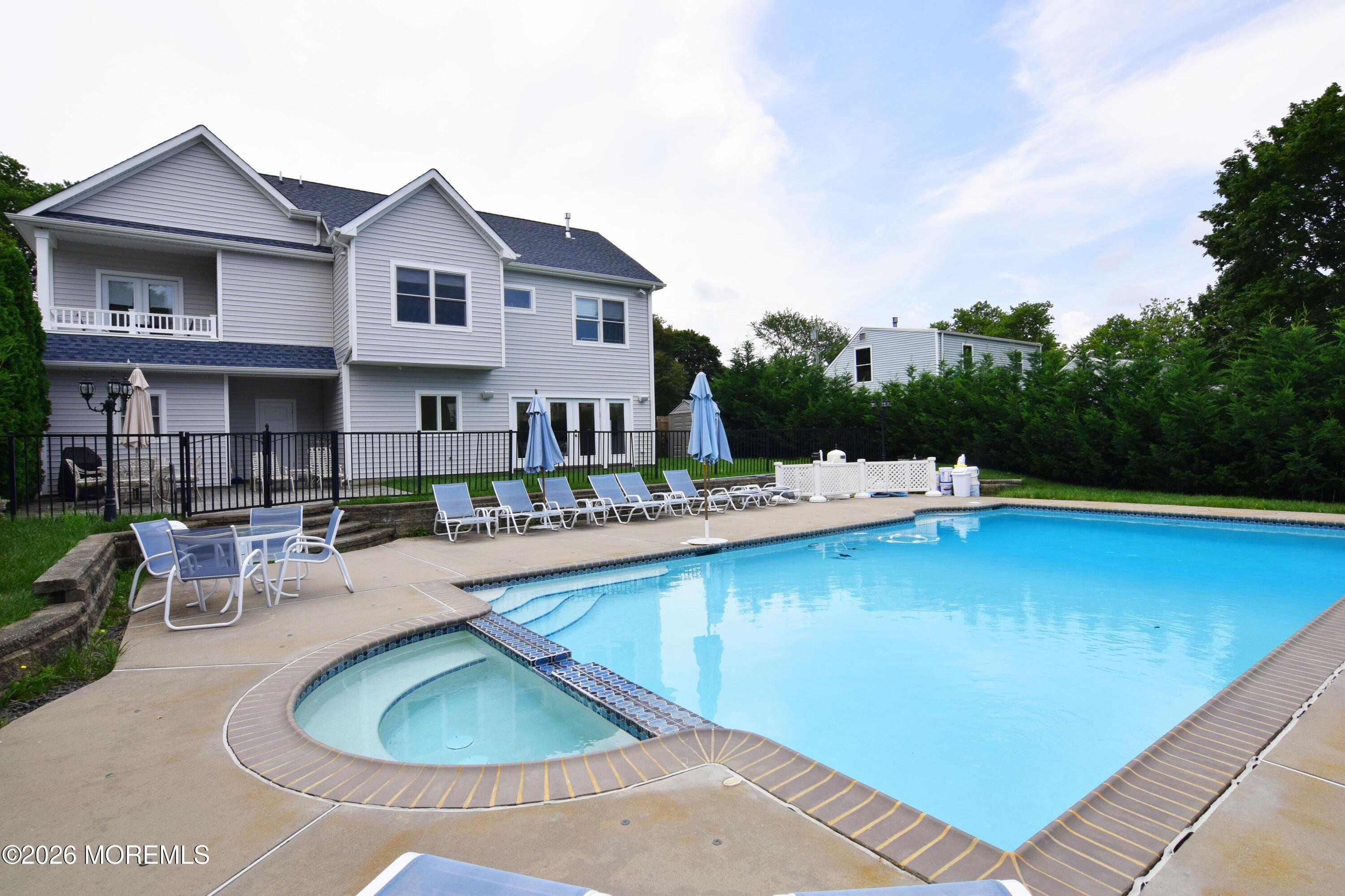 229 Lockwood Avenue, Unit WINTER Long Branch, NJ 07740 - Photo 18 of 19 a swimming pool with outdoor seating and yard