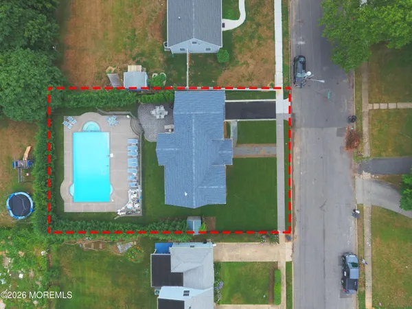 an aerial view of a house with a swimming pool