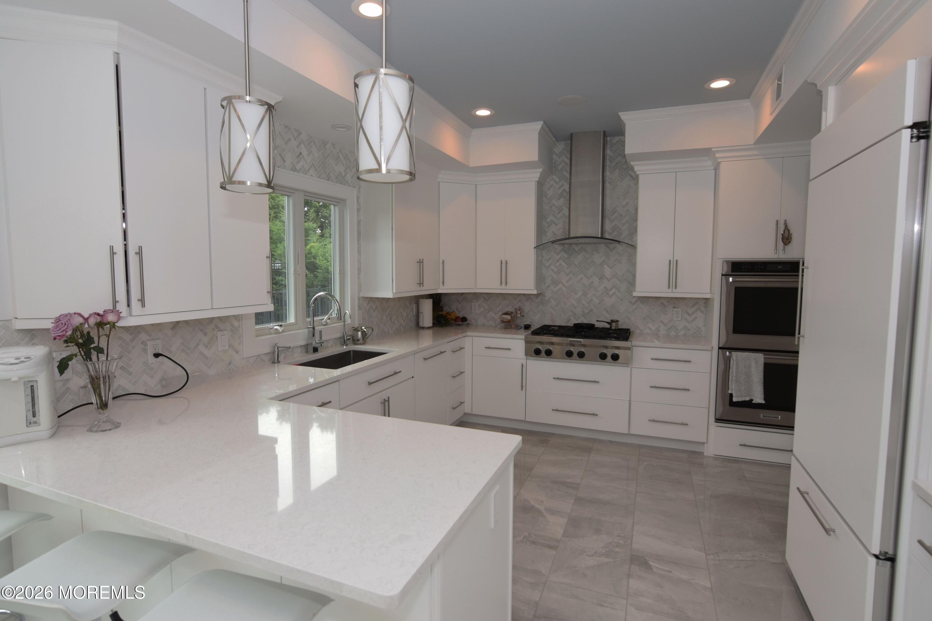 229 Lockwood Avenue, Unit WINTER Long Branch, NJ 07740 - Photo 5 of 19 a kitchen with stainless steel appliances granite countertop a sink a stove and a refrigerator