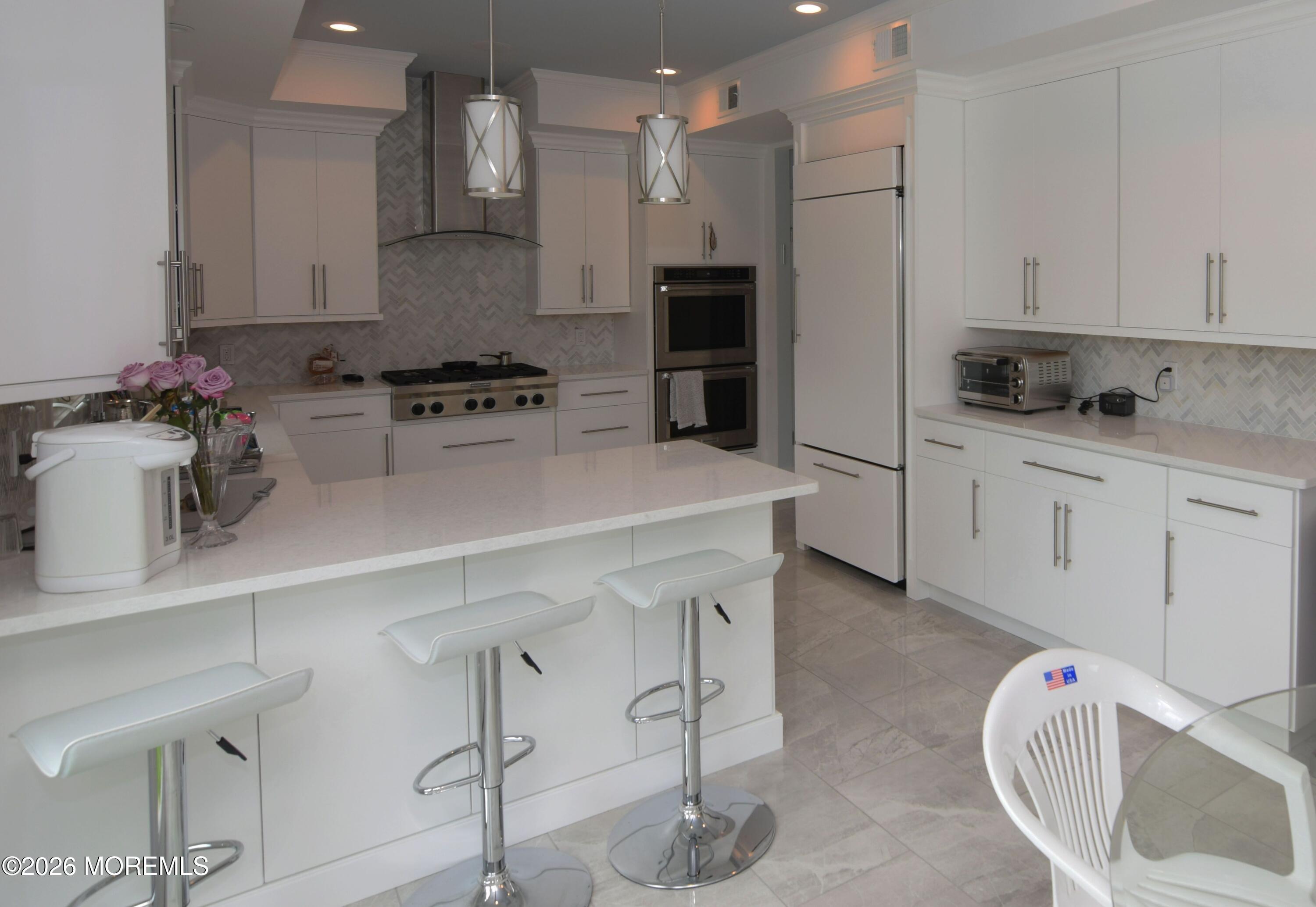 229 Lockwood Avenue, Unit WINTER Long Branch, NJ 07740 - Photo 6 of 19 a kitchen with stainless steel appliances a sink a stove a refrigerator and cabinets