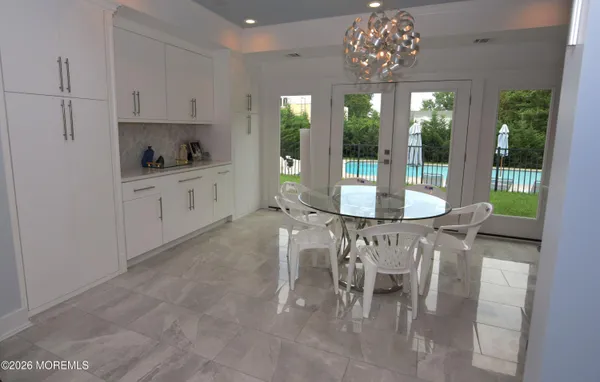 a view of a dining room with furniture wooden floor and chandelier