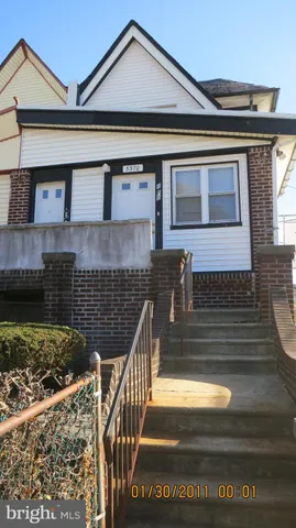 a front view of a house with stairs