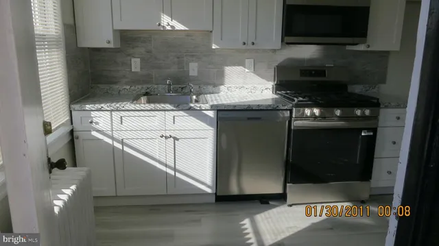a kitchen with a sink and a stove top oven