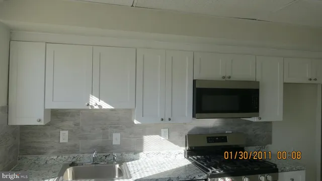a kitchen with a stove and a microwave