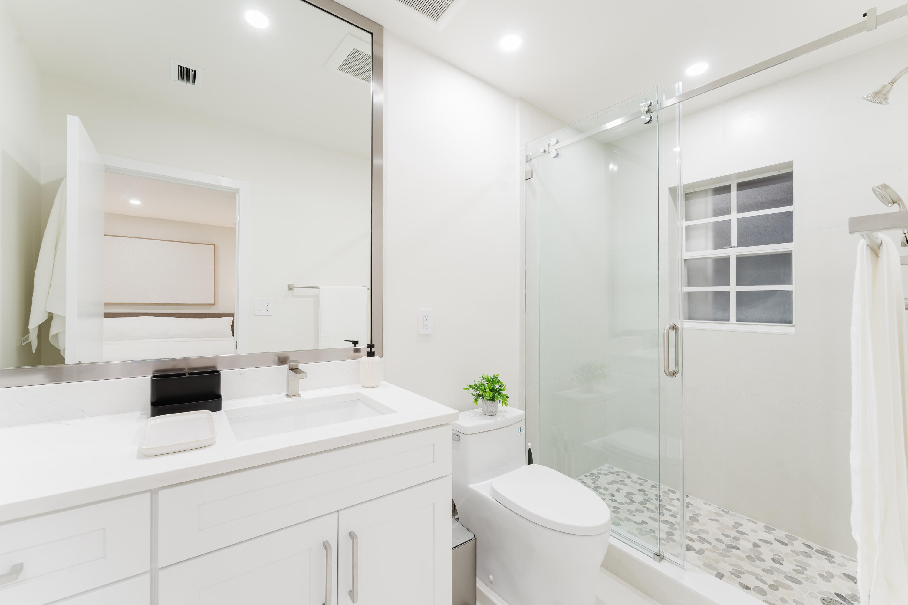 3199 Northeast 6th Drive Boca Raton, FL 33431 - Photo 28 of 49 a bathroom with a sink a toilet and shower