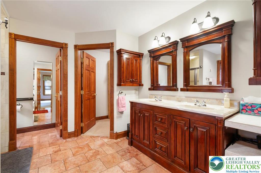 1222 Spring Road Andreas, PA 18211 - Photo 25 of 44 Rich wood trim and dual vanities
anchor this classic bathroom space
featuring warm tile flooring.