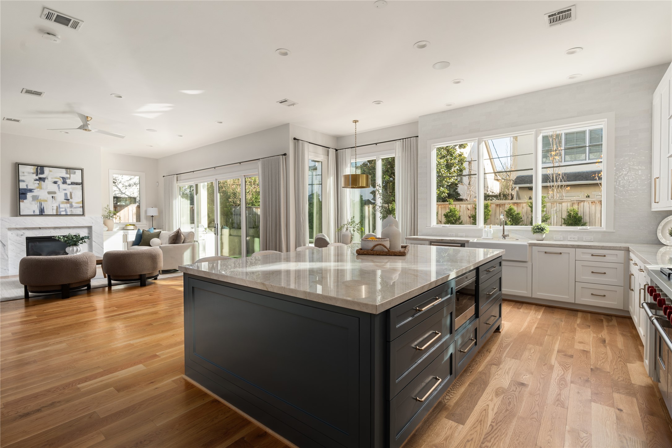 2715 Robinhood Street Houston, TX 77005 - Photo 24 of 48 This expansive open-concept kitchen anchors the home with an oversized quartz island, custom cabinetry, and seamless sightlines to the living area, all bathed in abundant natural light for effortless everyday living and entertaining.