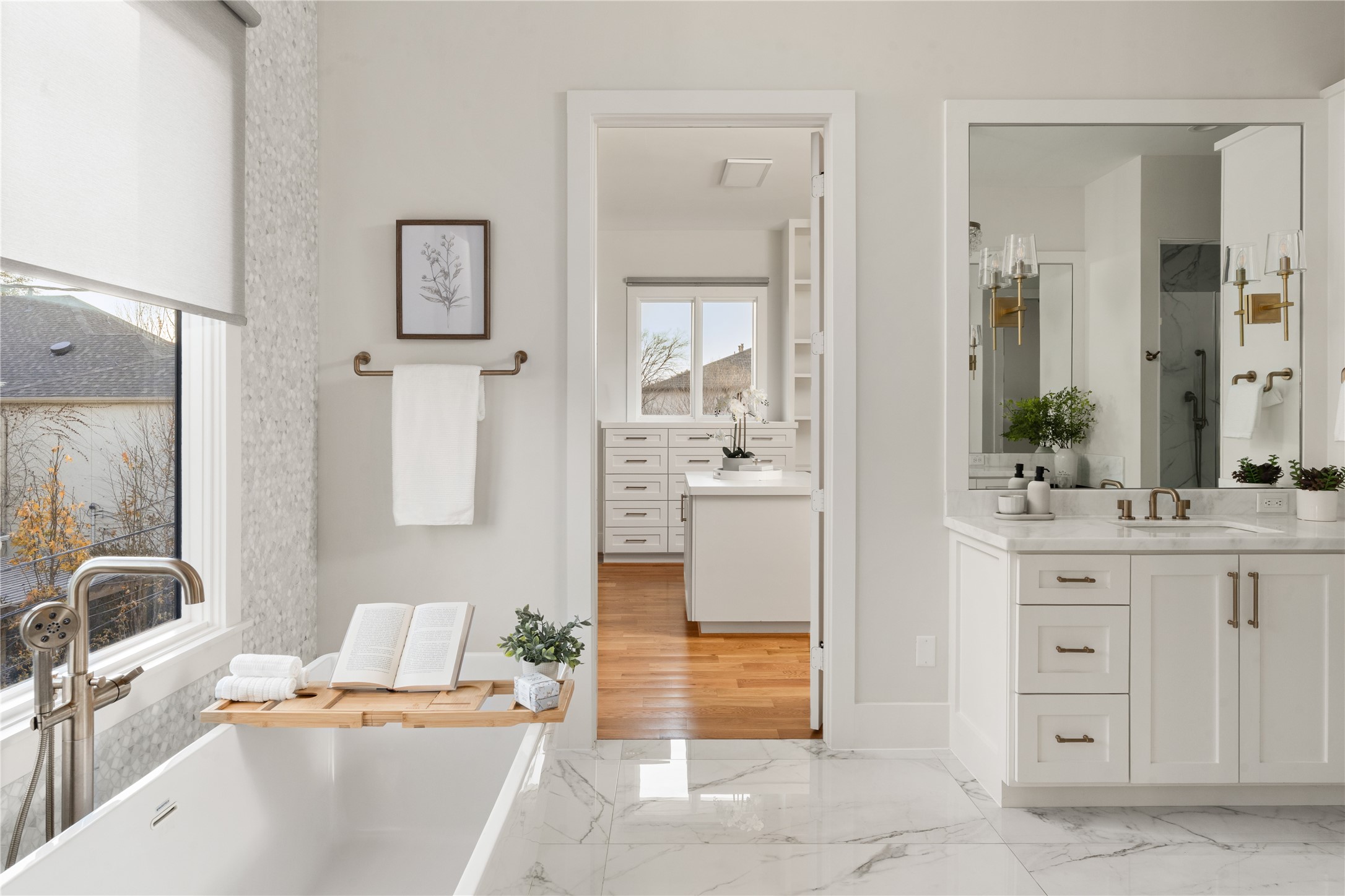 2715 Robinhood Street Houston, TX 77005 - Photo 27 of 48 This spa-inspired primary bath showcases a freestanding soaking tub, elegant marble finishes, dual vanity, and seamless access to a custom walk-in closet, creating a luxurious retreat for daily living.
