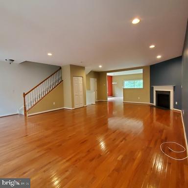 528 Van Dyke Circle Newark, DE 19702 - Photo 4 of 17 an empty room with wooden floor and windows