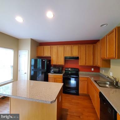 528 Van Dyke Circle Newark, DE 19702 - Photo 9 of 17 a kitchen with stainless steel appliances granite countertop a sink stove and refrigerator