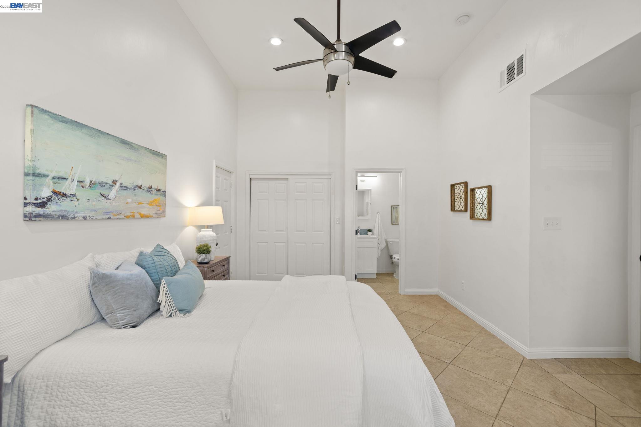 167 Peninsula Road Bay Point, CA 94565 - Photo 20 of 58 a bedroom with a bed and a painting on the wall