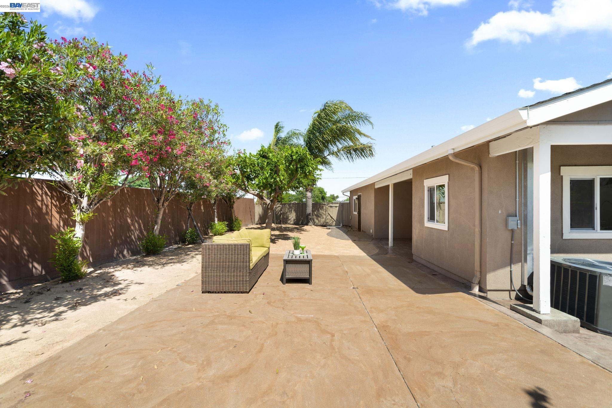 167 Peninsula Road Bay Point, CA 94565 - Photo 26 of 58 a view of a patio with couches and table and chairs next to yard and trees