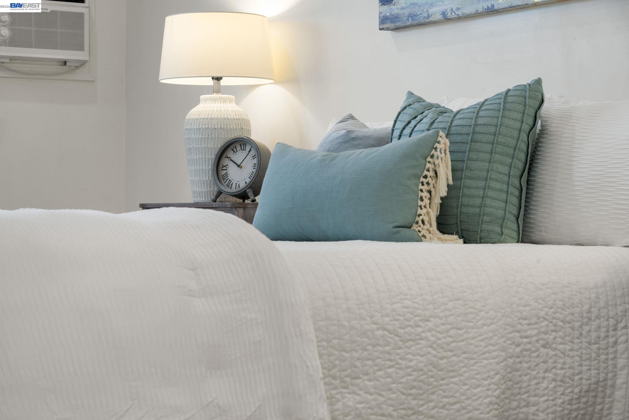 167 Peninsula Road Bay Point, CA 94565 - Photo 47 of 58 a bed sitting in a bedroom next to a lamp