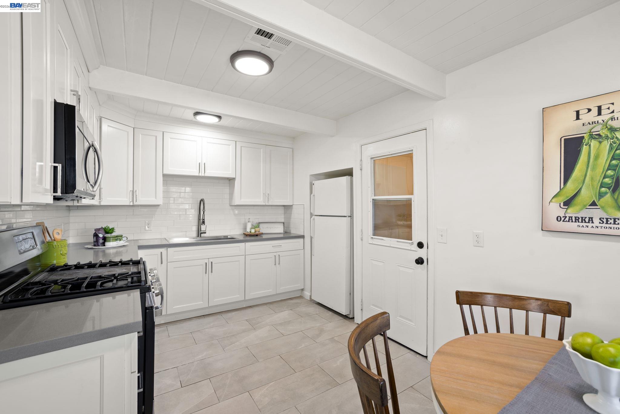 167 Peninsula Road Bay Point, CA 94565 - Photo 8 of 58 a kitchen with a refrigerator and a stove