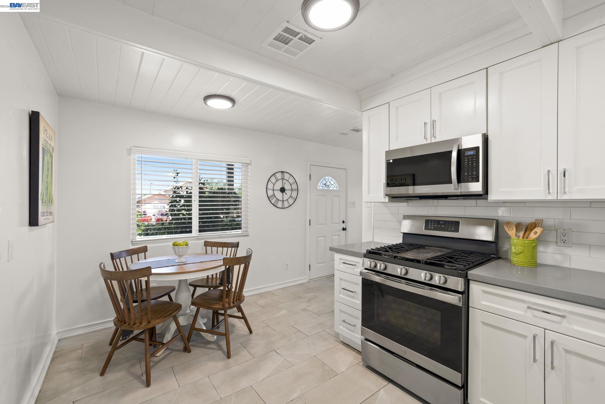 167 Peninsula Road Bay Point, CA 94565 - Photo 10 of 58 a kitchen with stainless steel appliances a stove a microwave cabinets and a dining table