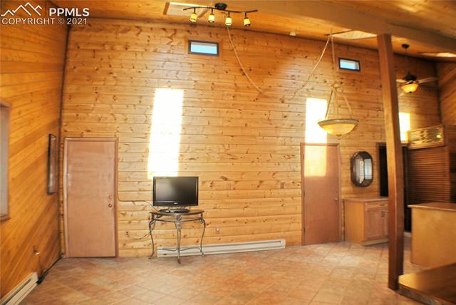 262-338 Post Road Guffey, CO 80820 - Photo 4 of 34 Large Living Room Space with Tongue & Groove Paneling and Tiled Floors